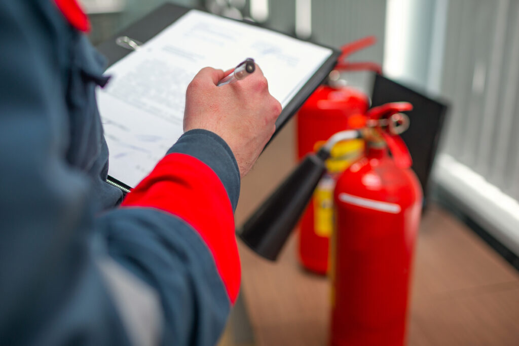 Professional technician inspecting a fire extinguisher